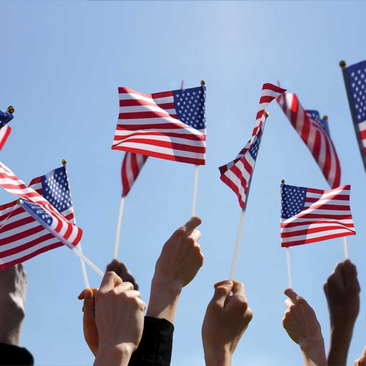hands holding up American flags